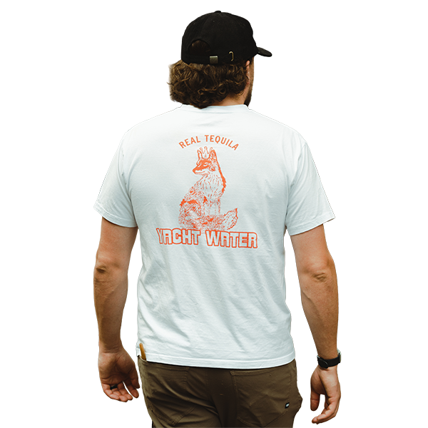 A man wearing a yacht water classic tee in white with orange logo